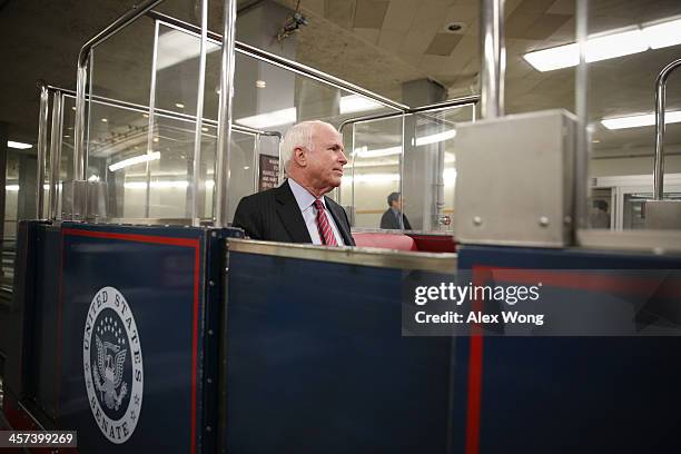 Sen. John McCain boards the Senate subway after a vote December 17, 2013 on Capitol Hill in Washington, DC. The Senate has passed a cloture vote to...