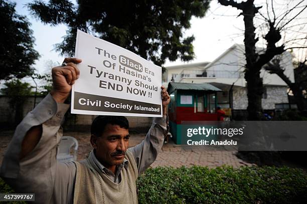 Member of the Civil Society Islamabad holds up a sign during a protest outside the Bangladesh high commission to condemn the execution of Bangladesh...