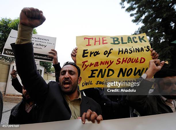 Members of the Civil Society Islamabad hold signs and shout slogans during a protest outside the Bangladesh high commission to condemn the execution...