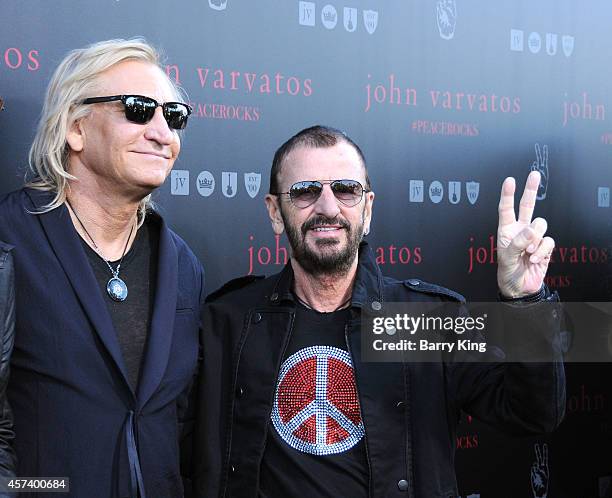 Musicians Joe Walsh and Ringo Starr attend the International Peace Day celebration at John Varvatos on September 21, 2014 in Los Angeles, California.