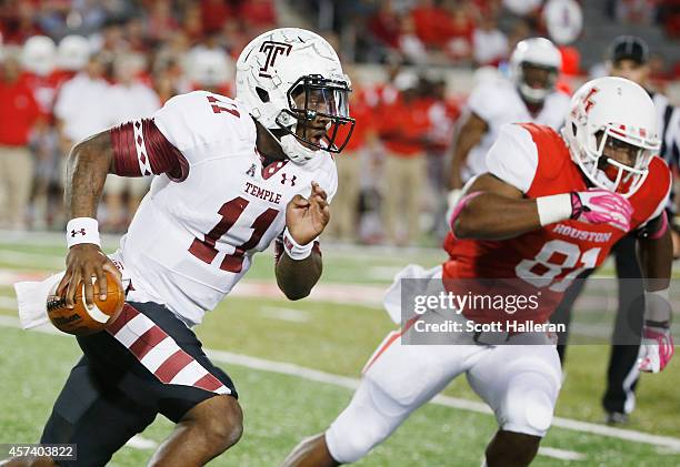 Walker of the Temple Owls scrambles past Tyus Bowser of the Houston Cougars in the first half of their game at TDECU Stadium on October 17, 2014 in...