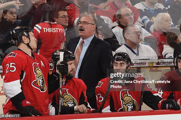 Gead coach Paul MacLean of the Ottawa Senators looks on from the bench during an NHL game against the Toronto Maple Leafs at Canadian Tire Centre on...