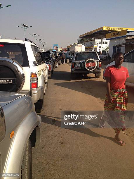 Residents queue up for fuel at a gas station in Juba, the South Sudanese capital, on December 16 following fighting in the city overnight. Rival...