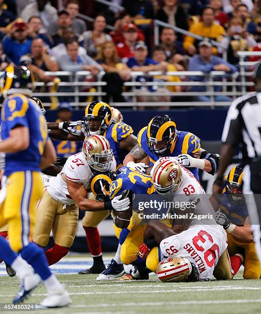 Michael Wilhoite, Demarcus Dobbs and Ian Williams of the San Francisco 49ers stop Zac Stacy of the St. Louis Rams during the game at the Edward Jones...