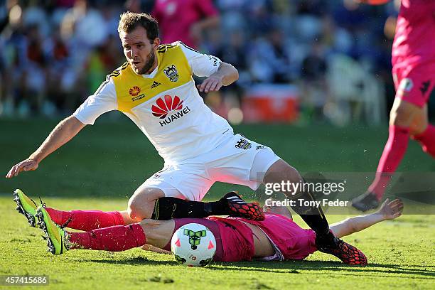 Jeremy Brockie of the Phoenix is brought down in the penalty box by Jacob Poscoliero of the Mariners during the round two A-League match between the...