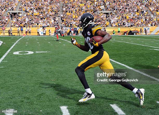 Cornerback Cortez Allen of the Pittsburgh Steelers runs with the football after intercepting a pass during a game against the Tampa Bay Buccaneers at...