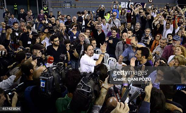 Pablo Iglesias , leader of Podemos, a left-wing party that emerged out of the "Indignants" movement greets supporters as he arrives to a party...