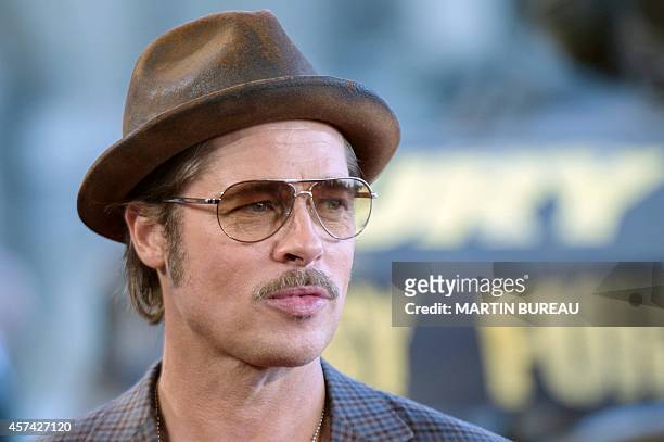 Actor Brad Pitt poses during a photocall for the film "Fury", on October 18, 2014 in Paris. AFP PHOTO / MARTIN BUREAU