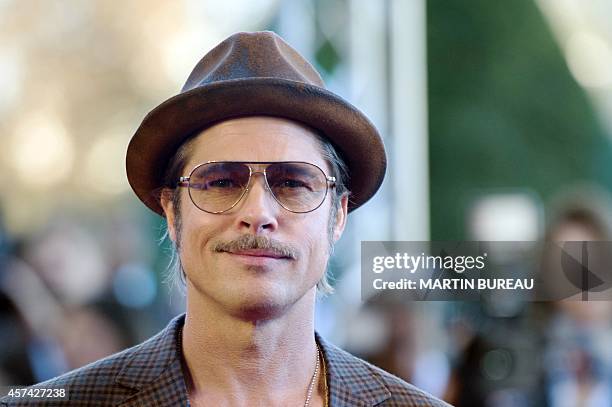Actor Brad Pitt poses during a photocall for the film "Fury", on October 18, 2014 in Paris. AFP PHOTO / MARTIN BUREAU
