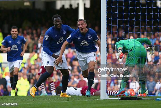 Phil Jagielka of Everton turns to celebrate after scoring the opening goal during the Barclays Premier League match between Everton and Aston Villa...