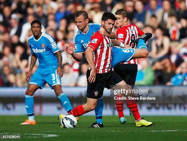 Lee Cattermole of Sunderland grabs Shane Long of Southampton during the Barclays Premier League match between Southampton and Sunderland at St Mary's...