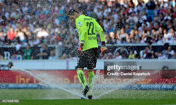 Thorsten Kirschbaum of Stuttgart tries to stop a lawn sprinkler during the Bundesliga match between VfB Stuttgart and Bayer 04 Leverkusen at...