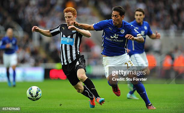 Newcastle player Jack Colback challenges Leonardo Ulloa of Leicester during the Barclays Premier League match between Newcastle United and Leicester...