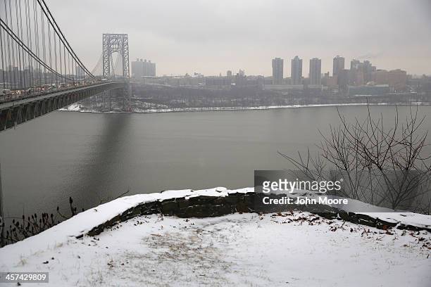 Snow covers the Palisades Interstate Park overlooking the George Washington Bridge between New York City , and Fort Lee, New Jersey on December 17,...