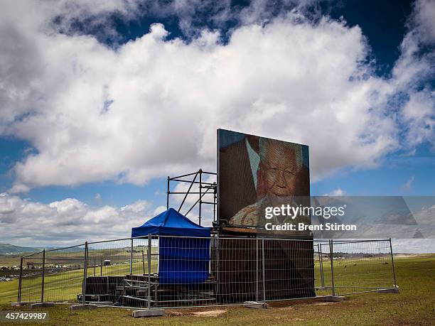 Local people watches the Mandela funeral service on a large television situated on a hilltop overlooking the service in the valley below, Qunu, South...