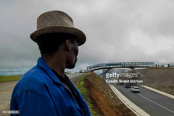 Man waits for the Nelson Mandela funeral procession to pass, Qunu, South Africa, 14 December 2014. An icon of democracy, Mandela was buried at his...
