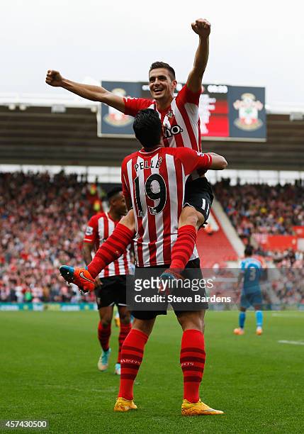 Graziano Pelle of Southampton is congratulated by Dusan Tadic as he scores their fifth goal during the Barclays Premier League match between...