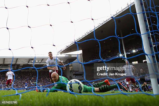 Brad Guzan of Aston Villa watches the ball as Romelu Lukaku of Everton scores their second goal during the Barclays Premier League match between...