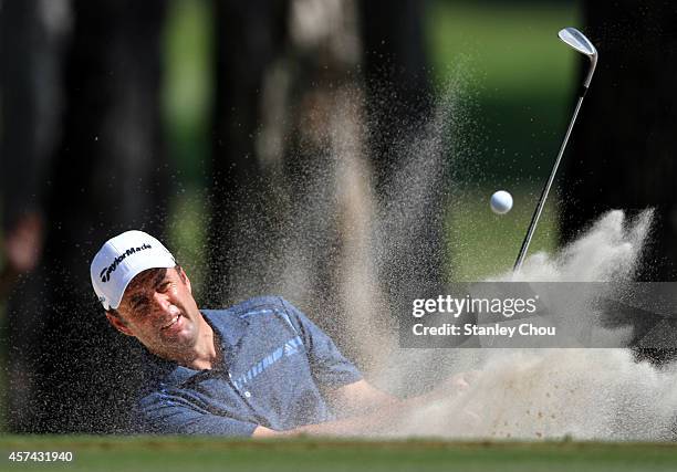 Richard Bland of England plays a bunker shot on the 9th hole during the 3rd round of the 2014 Hong Kong open at The Hong Kong Golf Club on October...