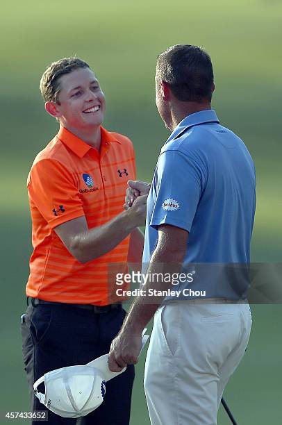 Cameron Smith and Scott Hend of Australia shakes hands on the 18th hole during the 3rd round of the 2014 Hong Kong open at The Hong Kong Golf Club on...