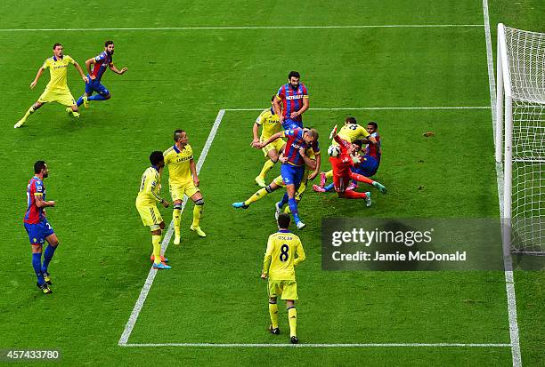 Brede Hangeland of Crystal Palace is blocked by Thibaut Courtois of Chelsea during the Barclays Premier League match between Crystal Palace and...