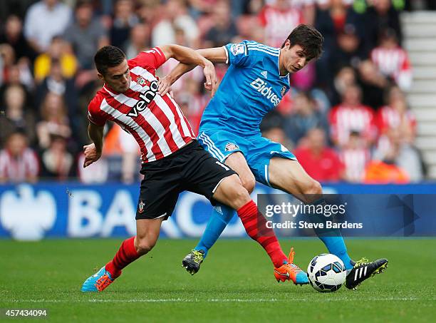 Dusan Tadic of Southampton battles with Santiago Vergini of Sunderland during the Barclays Premier League match between Southampton and Sunderland at...