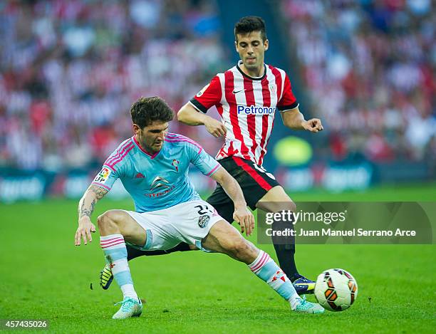 Markel Susaeta of Athletic Club duels for the ball with Carles Planasof Celta de Vigo during the La Liga match between Athletic Club and Celta de...