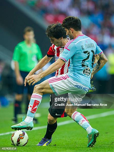 Andoni Iraola of Athletic Club duels for the ball with Carles Planas of Celta de Vigo during the La Liga match between Athletic Club and Celta de...