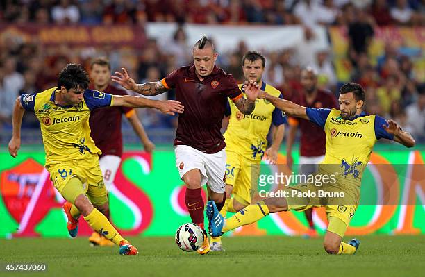 Radja Naiggolan of AS Roma competes for the ball with AC Chievo Verona players during the Serie A match between AS Roma and AC Chievo Verona at...