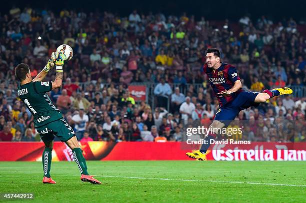 Lionel Messi of FC Barcelona heads the ball under a challenge by Xabi Irureta of SD Eibar during the La Liga match between FC Barcelona and SD Eibar...