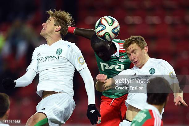 Baye Oumar Niasse of FC Lokomotiv Moscow is challenged by Adilson and Andrei Semyonov of FC Terek Grozny during the Russian Premier League match...