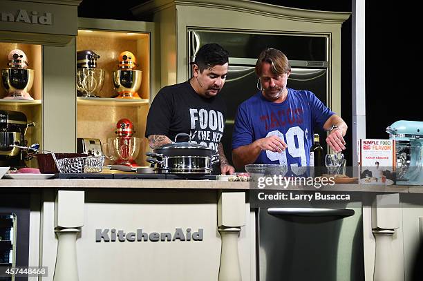 Chefs Aaron Sanchez and John Besh give a cooking demonstration at the Grand Tasting presented by ShopRite featuring KitchenAid® culinary...