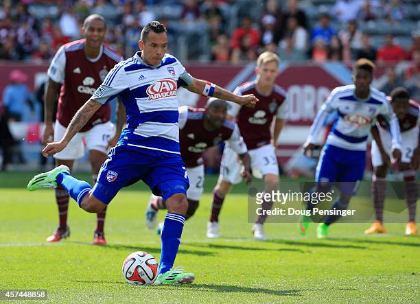 Blas Perez of FC Dallas scores a goal against goalkeeper Clint Irwin of Colorado Rapids on a penalty kick in the 56th minute as Marvell Wynne of...