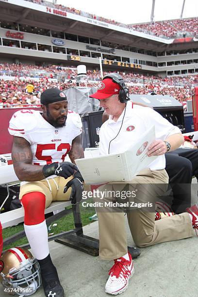 Linebackers Coach Jim Leavitt of the San Francisco 49ers talks with NaVorro Bowman during the game against the Tampa Bay Buccaneers at Raymond James...