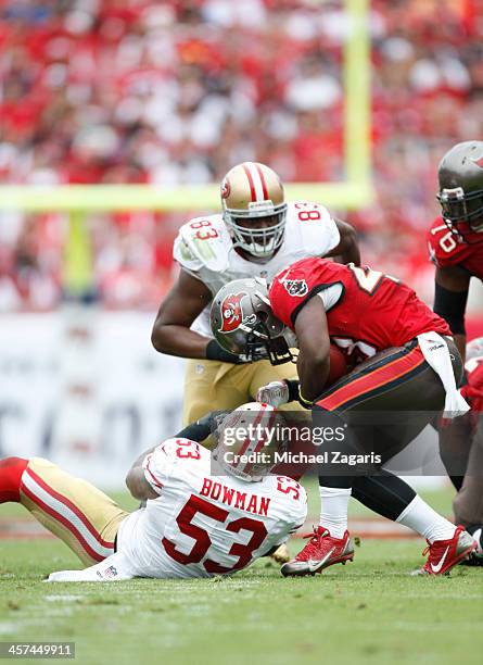 NaVorro Bowman and Demarcus Dobbs of the San Francisco 49ers tackles Bobby Rainey of the Tampa Bay Buccaneers during the game at Raymond James...