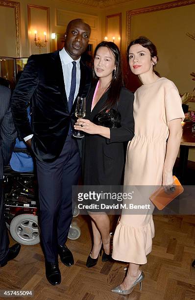 Ozwald Boateng, Rosey Chan and Lara Bohinc attend the Sindika Dokolo Art Foundation dinner at Cafe Royal on October 18, 2014 in London, England.