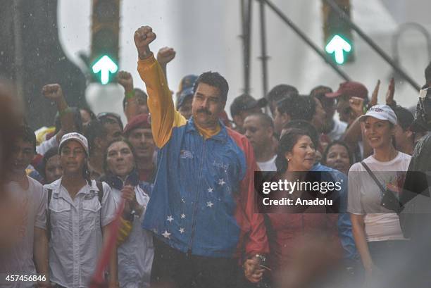 Venezuelan President Nicolas Maduro gestures during a demonstration in Caracas, on October 18, 2014. Venezuelan pro governments march at the streets...