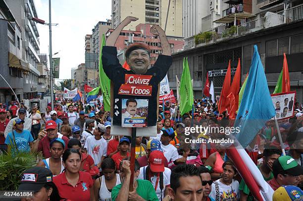 GGovernment supporters march against terrorism and for the peace in Caracas, on October 18, 2014. They hold banner of killed parliamentarian Robert...
