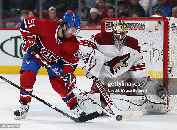 David Desharnais of the Montreal Canadiens tries to deflect a shot past Mike Smith of the Phoenix Coyotes during the second period at the Bell Centre...