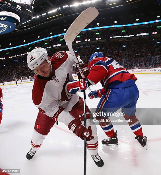 David Moss of the Phoenix Coyotes gets tangled up with Alex Galchenyuk of the Montreal Canadiens during the second period at the Bell Centre on...