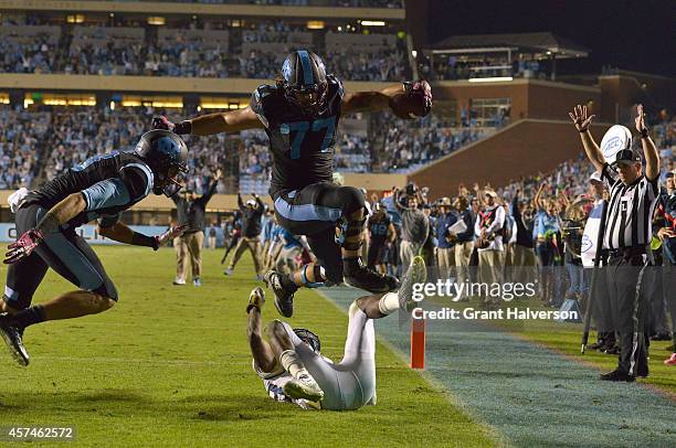 John Ferranto of the North Carolina Tar Heels hurdles D.J. White of the Georgia Tech Yellow Jackets on a two-point conversion with 11 seconds to play...