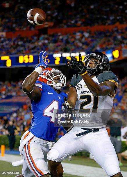 Bud Sasser of the Missouri Tigers catches a pass out of bounds in the endzone past the defense of Keanu Neal of the Florida Gators in during the...