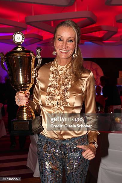 Renata Kochta and award attends the Monti Memorial Charity Gala at Hotel Vier Jahreszeiten on October 18, 2014 in Munich, Germany.