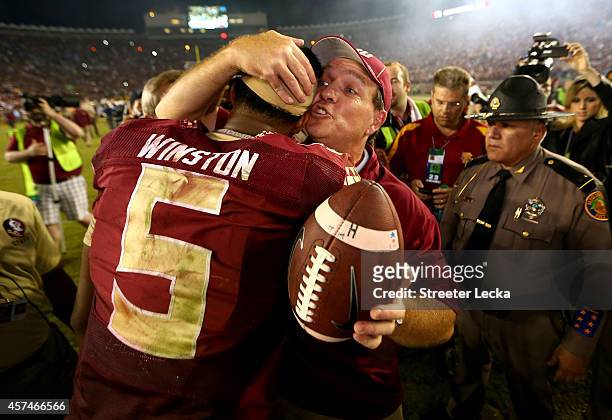 Head coach Jimbo Fisher of the Florida State Seminoles hugs Jameis Winston after defeating the Notre Dame Fighting Irish 31-27 in their game at Doak...