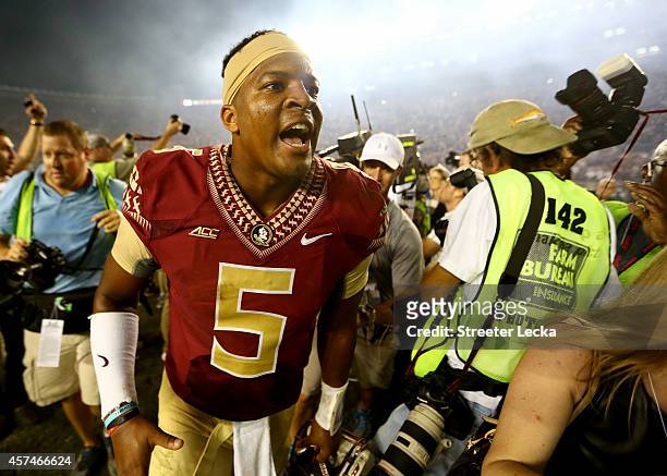 Jameis Winston of the Florida State Seminoles celebrates after defeating the Notre Dame Fighting Irish 31-27 at Doak Campbell Stadium on October 18,...