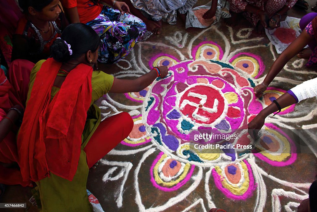 A girl is preparing the 'Rangoli' before the Diwali festival...
