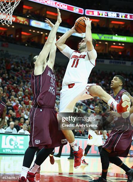 Luke Hancock of the Louisville Cardinals shooots the ball while defended by Tyler McCullough of the Missouri State Bears during the game at KFC YUM!...