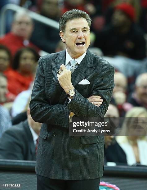 Rick Pitino the head coach of the Louisville Cardinals gives instructions to his team during the game against the Missouri State Bears at KFC YUM!...