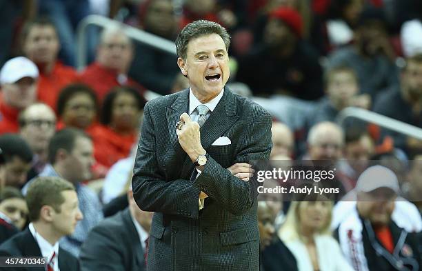 Rick Pitino the head coach of the Louisville Cardinals gives instructions to his team during the game against the Missouri State Bears at KFC YUM!...