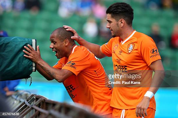 Henrique De Silva of the Roar celebrates after scoring a goal with Dimitri Petratos during the round two A-League match between the Perth Glory and...